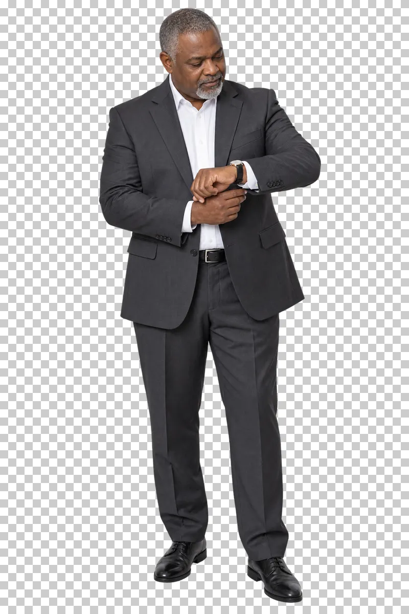 A man in a charcoal suit checking his wristwatch and adjusting his cuff.