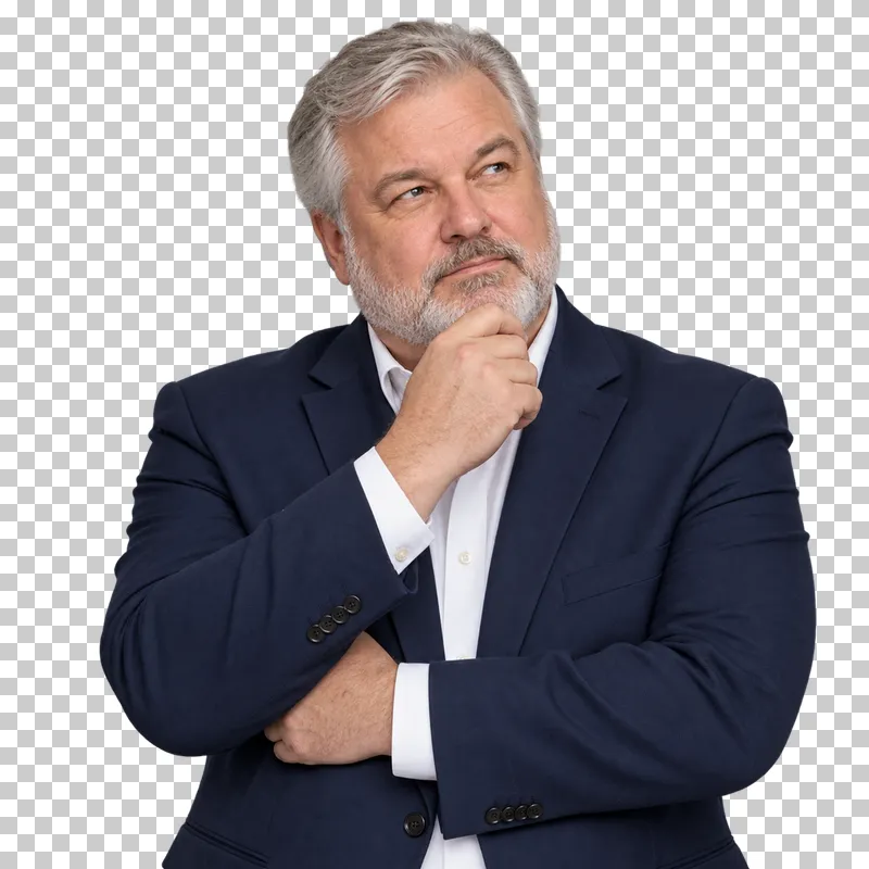 A waist-up portrait of a silver-haired man in a navy blazer with one hand under his chin.