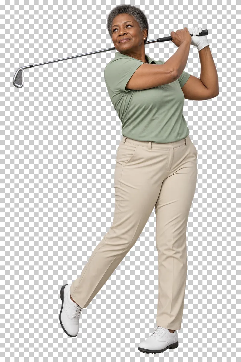 A woman in a sage polo and beige trousers finishing a golf swing with the club over her shoulder.