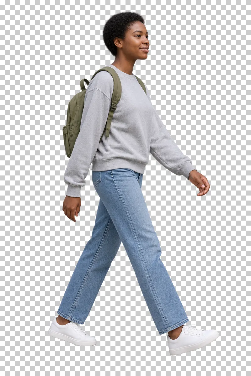 A woman with short natural hair, a gray sweatshirt and jeans walking with an olive backpack.