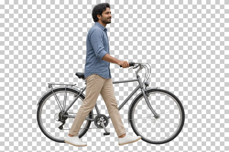 A man in a blue shirt walking beside a gray bicycle.