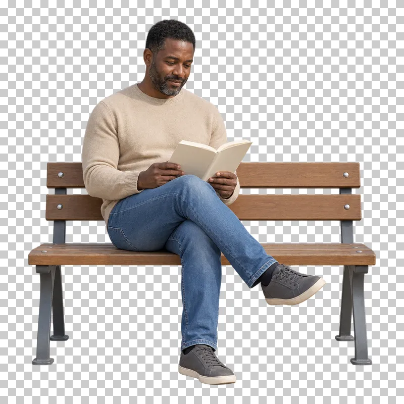 A man in a beige sweater and jeans reading a book on a wooden bench.