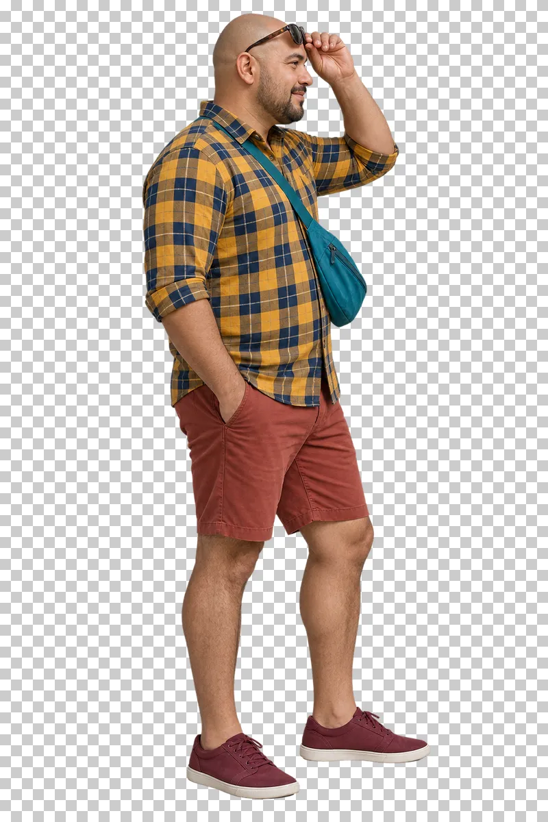 A man in a mustard checked shirt and rust shorts lifting his sunglasses above his forehead.