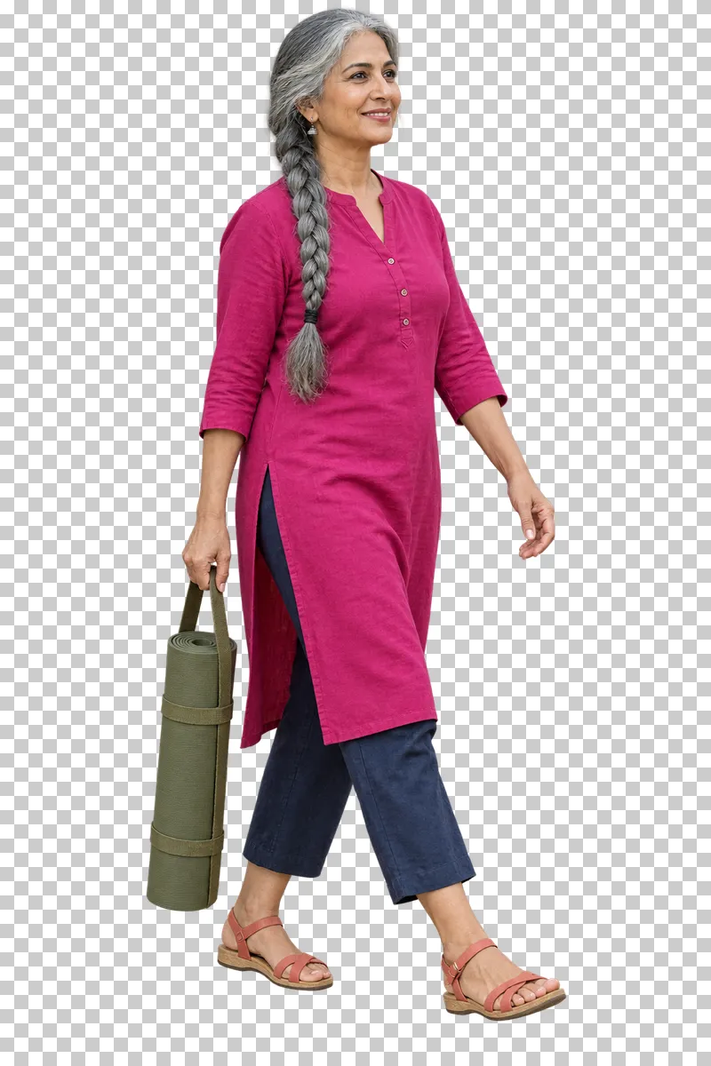 A silver-haired woman in a fuchsia tunic and indigo trousers carrying an olive yoga mat vertically in a sling.