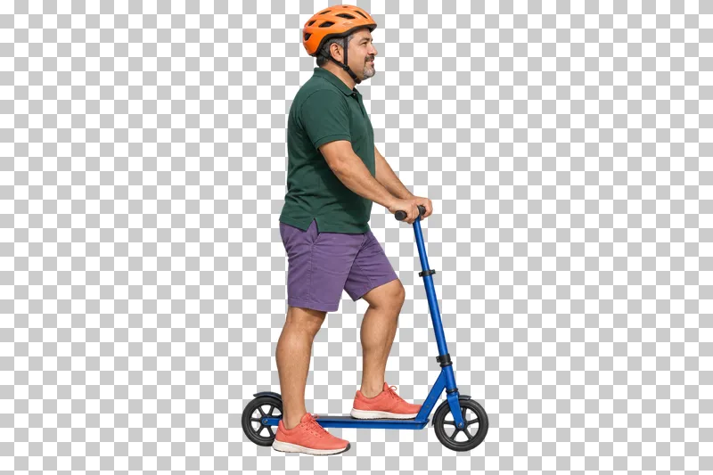A man in a green polo, violet shorts and orange helmet pausing on a cobalt kick scooter.