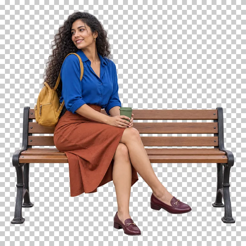 A woman in a cobalt blouse and rust skirt sitting on a wooden bench with a green coffee cup and mustard backpack.
