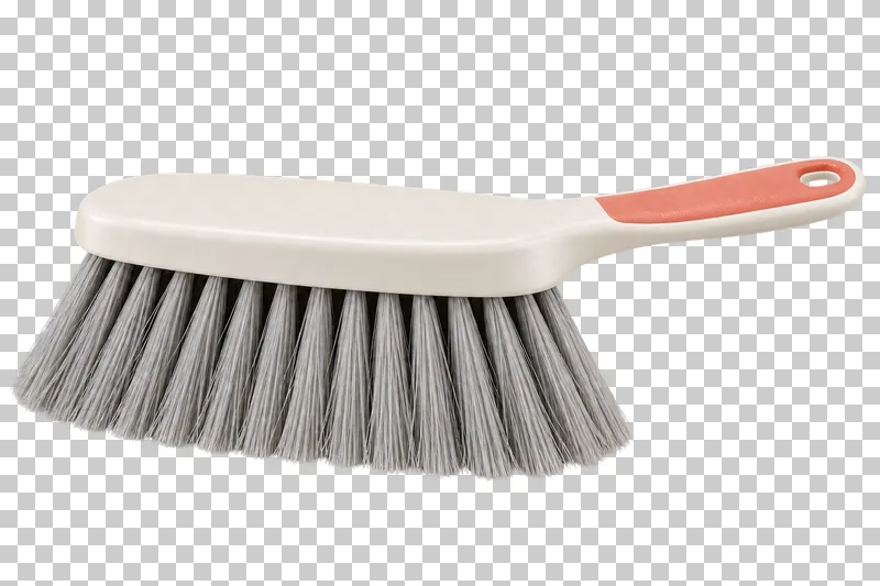 A hand brush with gray sweeping bristles and a slim white handle with a coral grip inset.