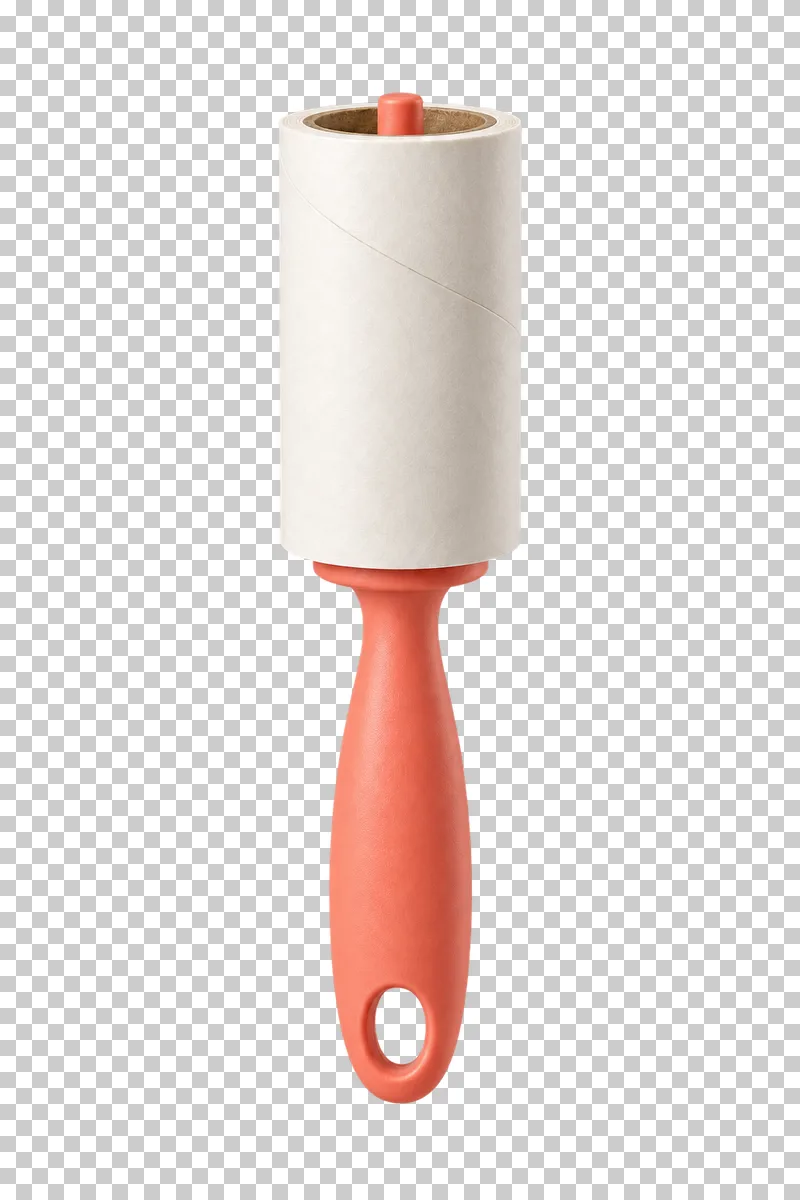 A white adhesive lint roller mounted on a central spindle above a coral handle.