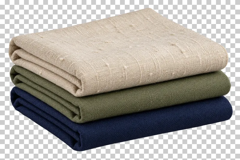 Three folded pieces of cream linen, olive cotton and navy cotton in a stack.