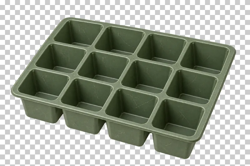 An empty green seed-starting tray with twelve recessed planting cells.