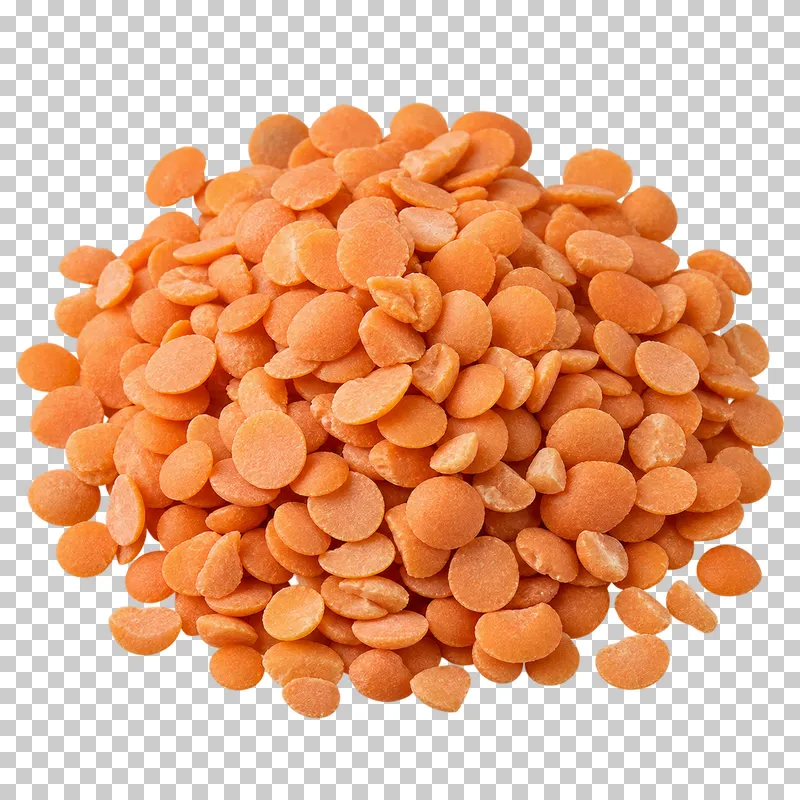 A small mound of red lentils with flattened orange halves in varied orientations.