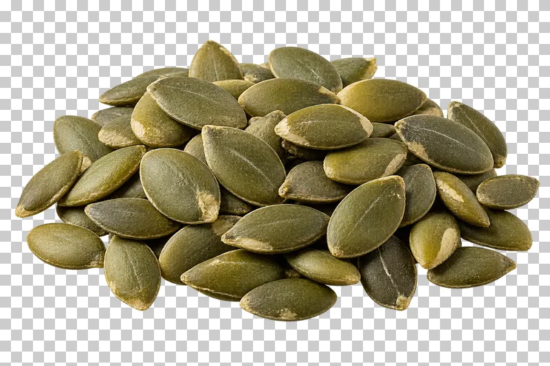 A small mound of shelled pumpkin seeds with flat oval kernels in muted green shades.