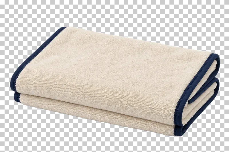 Folded microfiber towel in cream microfiber, navy bound edge, photographed as a complete isolated product on a transparent background.