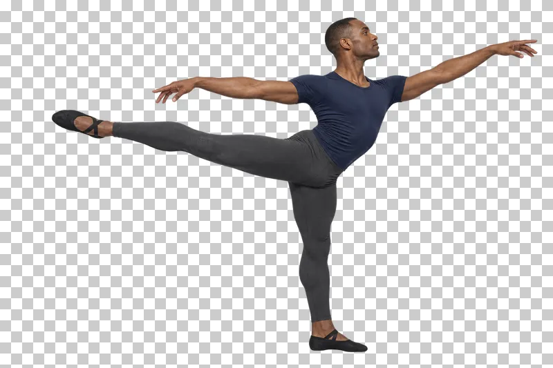 Male ballet dancer in a navy shirt and charcoal tights holding a low arabesque with open arms.