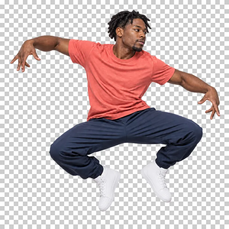 Male hip-hop dancer in a coral T-shirt and navy trousers performing a low tuck hop.