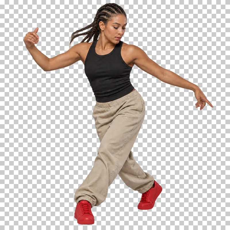 Breaking dancer in a black sleeveless top and beige trousers performing a standing toprock cross-step.