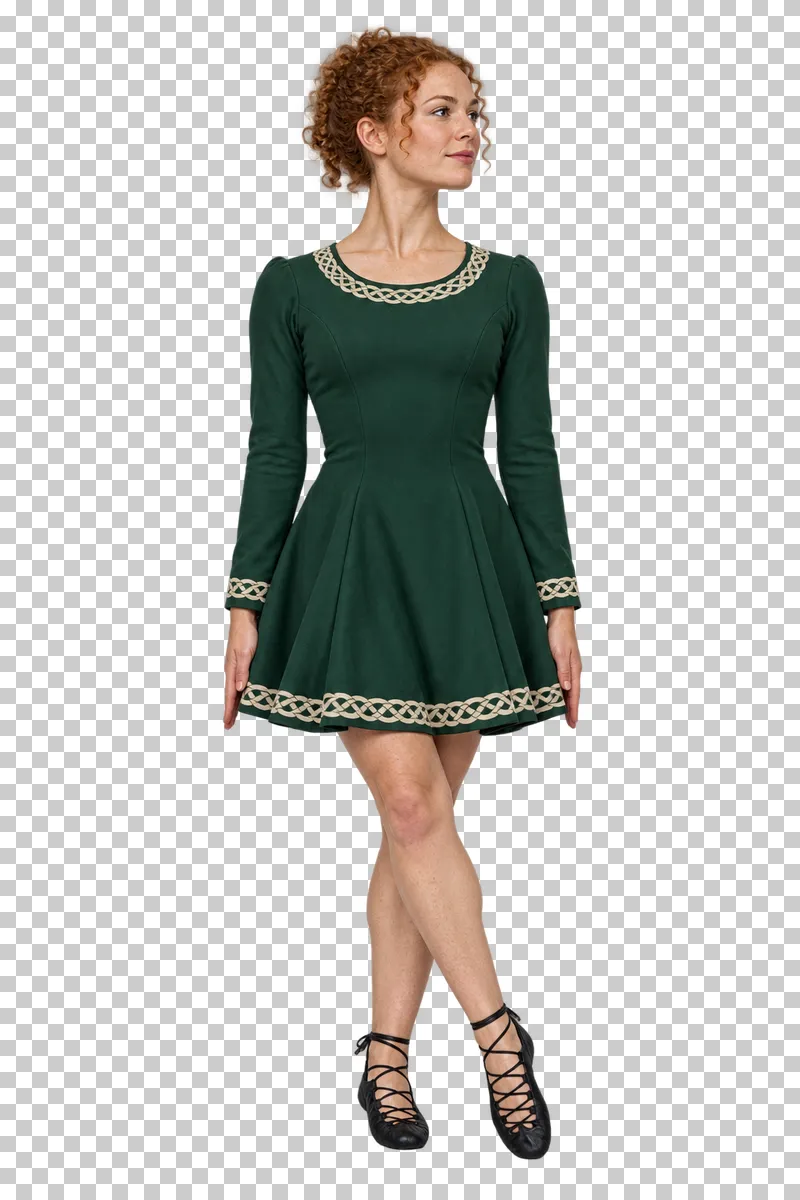 Irish dancer in a green knee-length dress and black ghillies standing with crossed feet and arms at her sides.