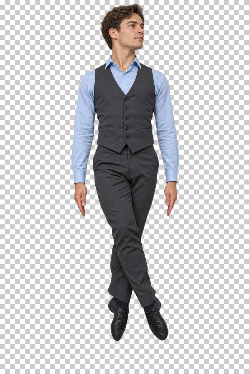 Male Irish dancer in a pale blue shirt and charcoal waistcoat performing a small crossed-foot jump.