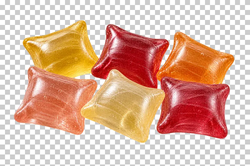 A small portion of pillow-shaped hard candies with pinched corners and translucent fruit-colored bodies.
