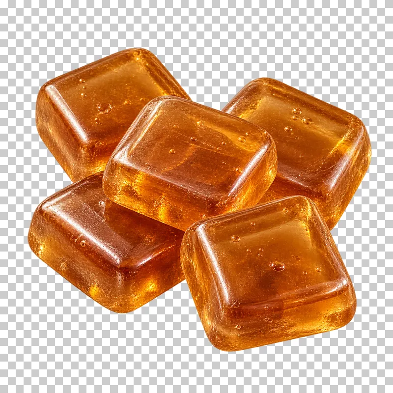 A small portion of square amber caramel hard candies with rounded corners and tiny trapped bubbles.