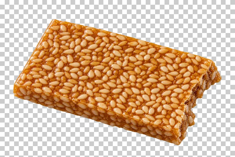 A thin golden sesame brittle slab with visible seeds and an irregular snapped edge.