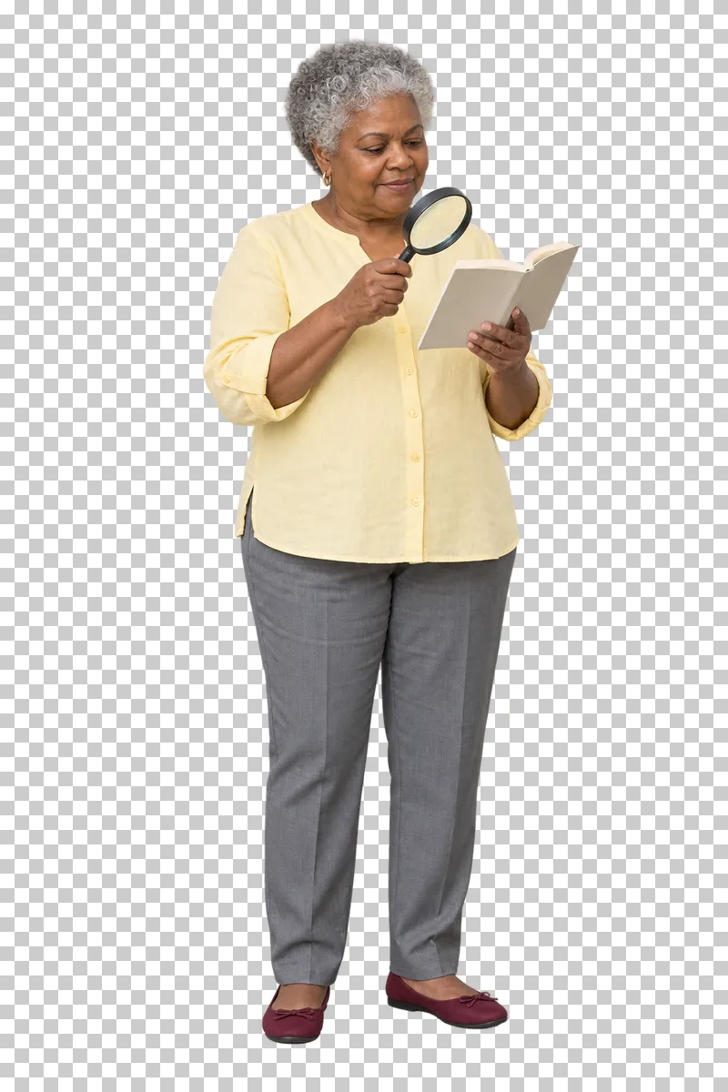 A woman reading a book with a handheld magnifier.
