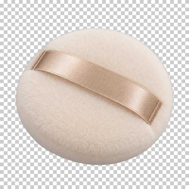 A round ivory powder puff with a black ribbon.