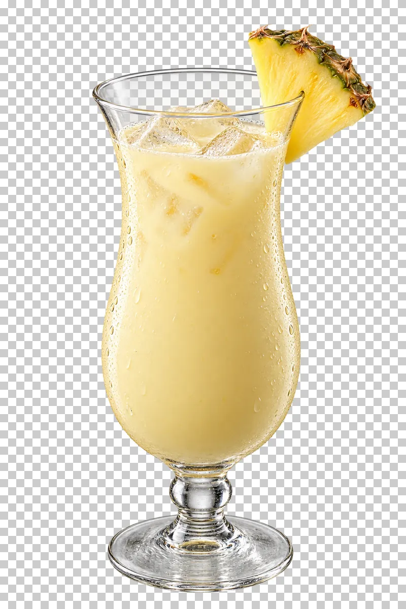 Creamy pineapple coconut mocktail with ice in a hurricane glass and pineapple on the rim.