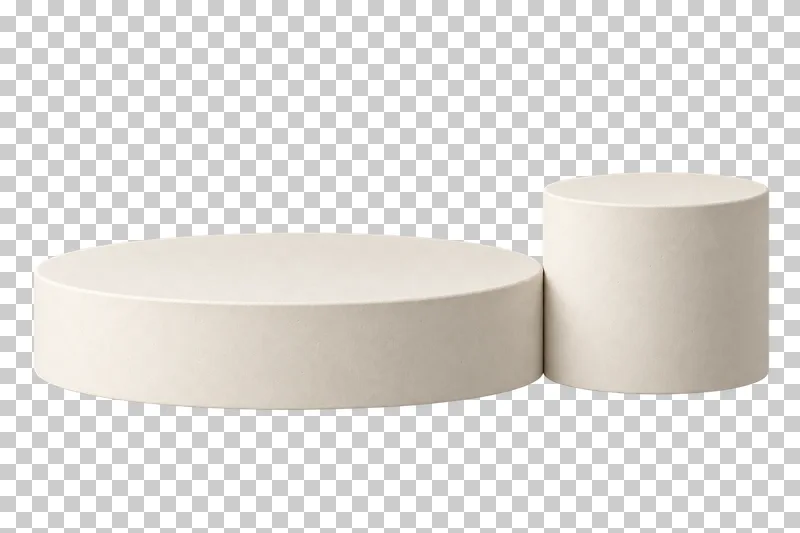 A broad low cream plaster circular base with a smaller taller cylinder beside its right edge.
