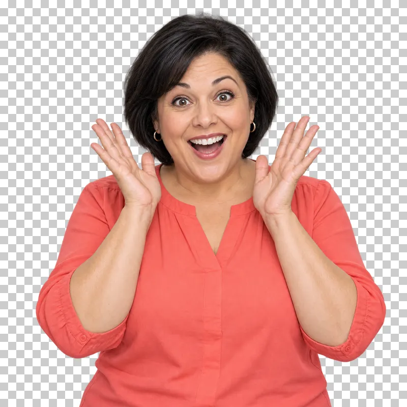 A woman in a coral blouse smiling in delighted surprise with both hands beside her cheeks.