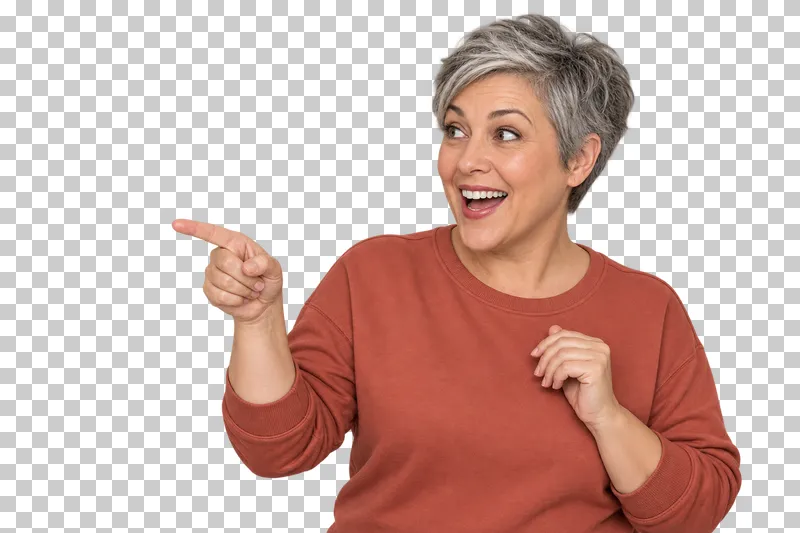 A silver-haired woman in a terracotta sweatshirt enthusiastically pointing to the left.