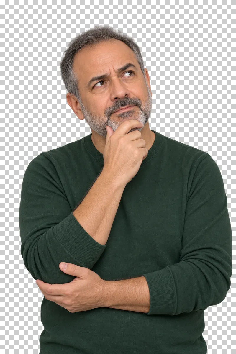 A grey-bearded man in a green top resting one hand under his chin in thought.