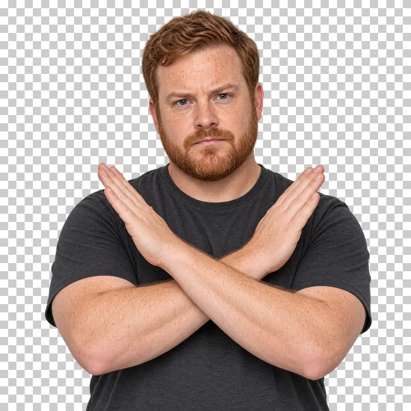 A red-haired bearded man in a charcoal T-shirt crossing his forearms to signal refusal.