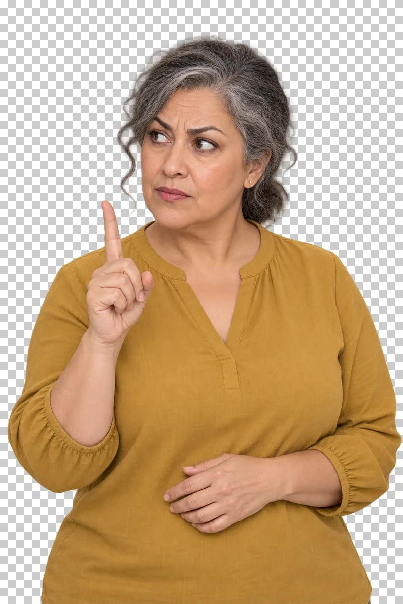 A grey-haired woman in a mustard blouse raising one index finger with a firm warning expression.