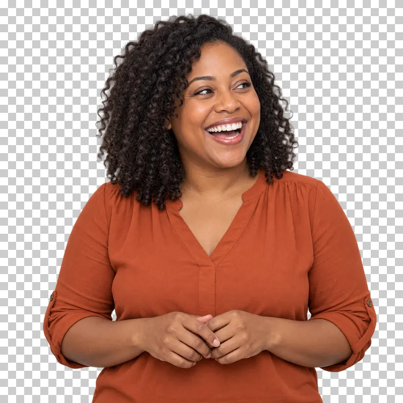 A curly-haired woman in a burnt orange blouse laughing broadly.