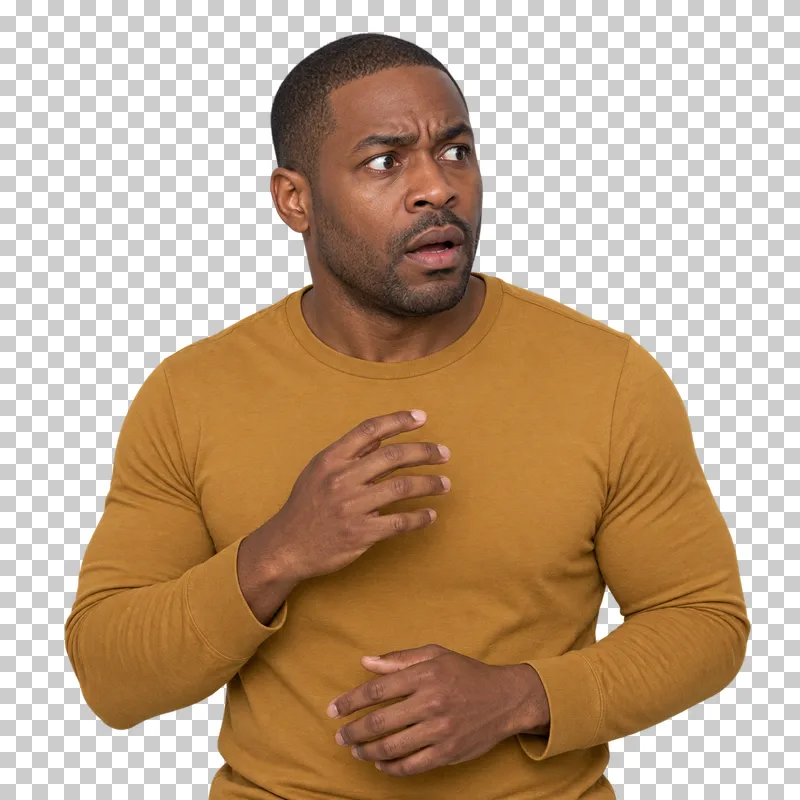A man in an ochre top with wide concerned eyes and a slightly open mouth reacting to bad news.