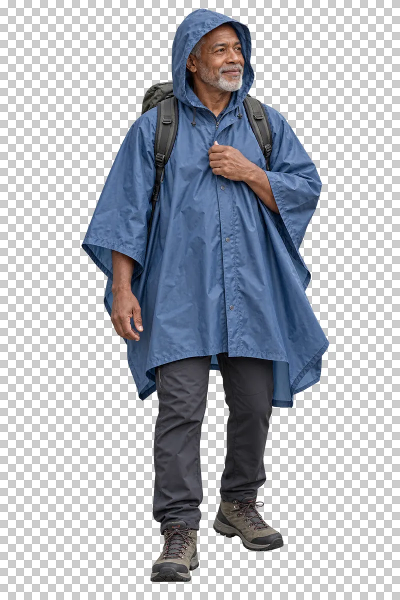A senior traveler standing in a hooded rain poncho.