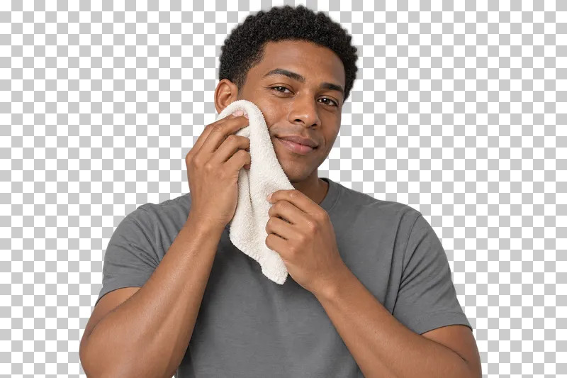 A person gently dries the face with a soft towel.