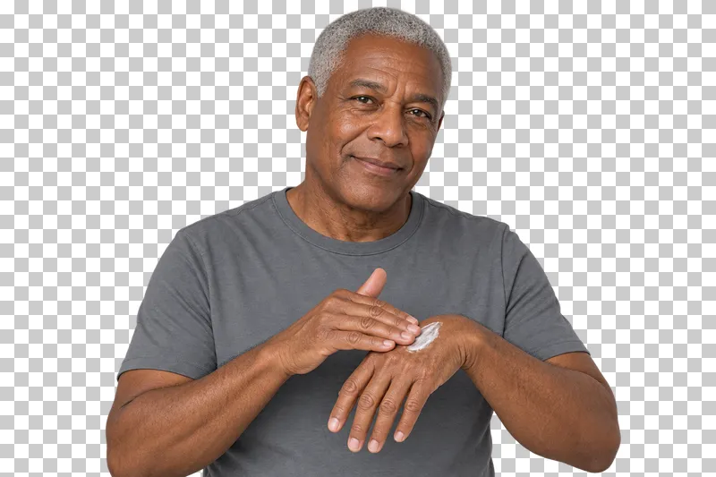 A person rubs hand cream between both hands.