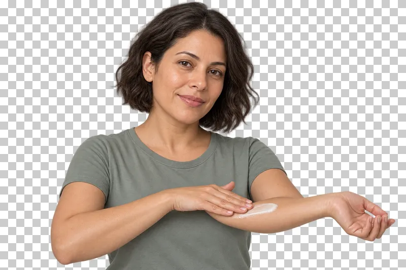 A person spreads body lotion onto a forearm.