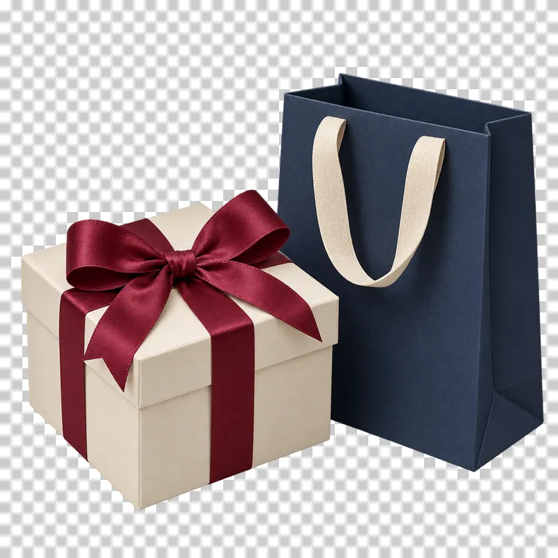 One cream gift box with a burgundy bow beside one navy gift bag with cream handles.