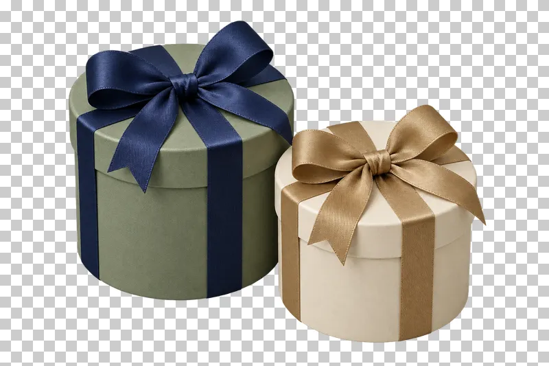 Two closed cylindrical sage and cream gift boxes of different heights with navy and muted-gold ribbons.