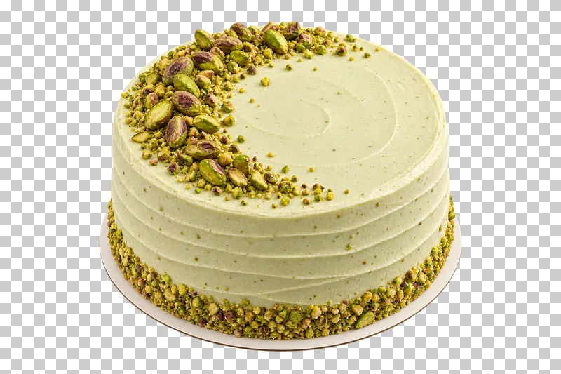 Whole pistachio cream cake with a crescent of pistachio kernels and chopped nuts around the base.
