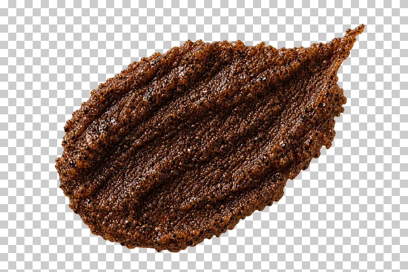 Dark coffee particles densely packed into a moist granular smear.