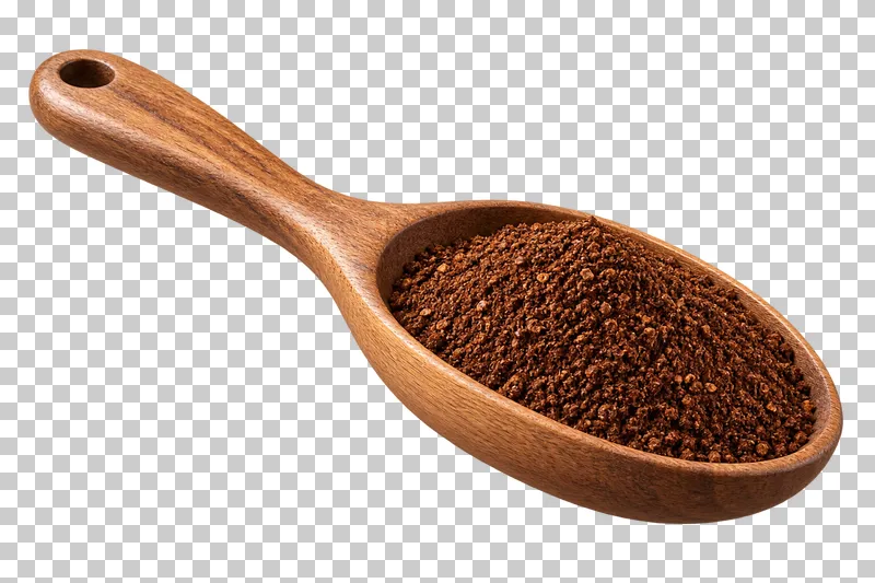 A wooden measuring spoon filled with ground coffee.