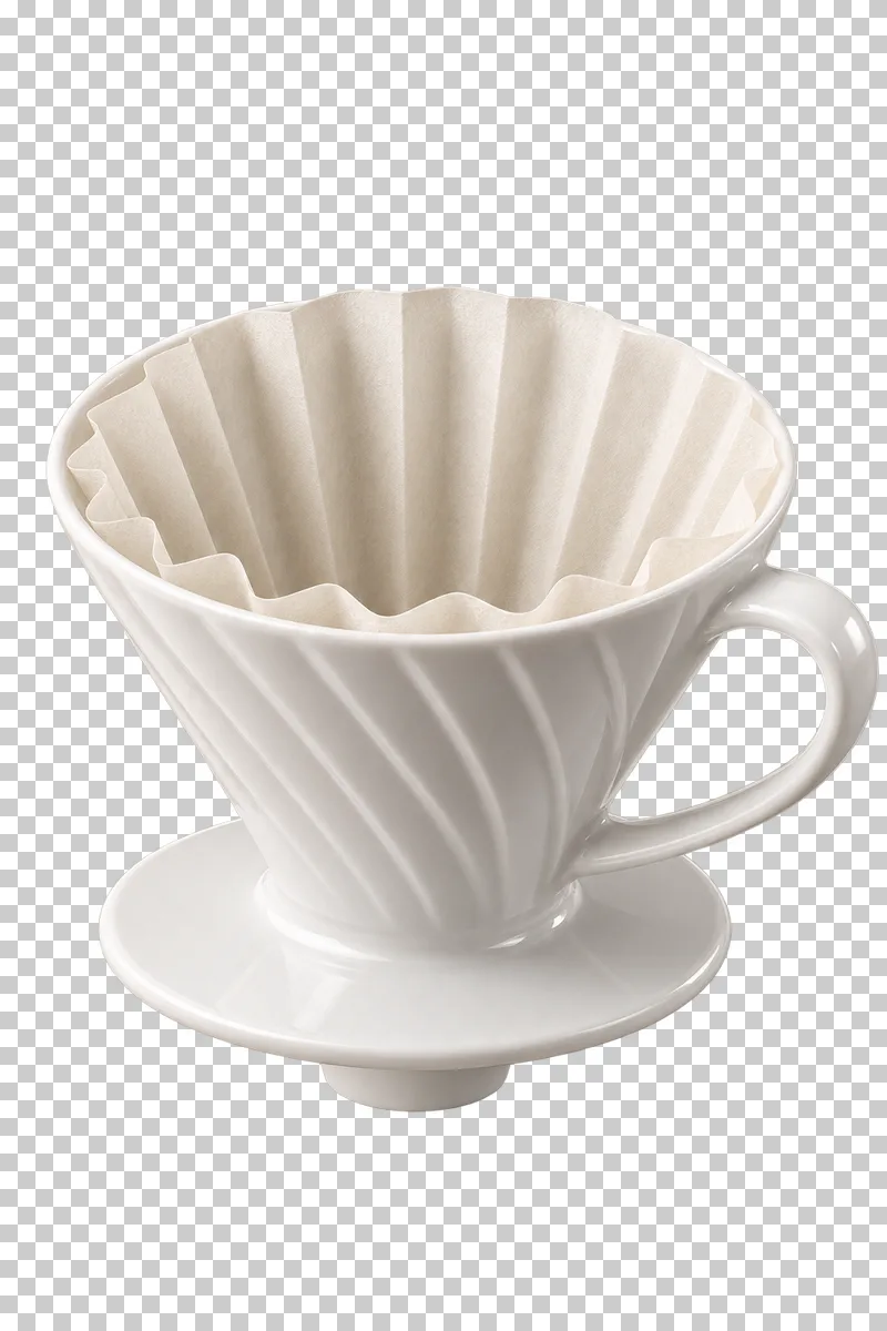 A white conical ceramic coffee dripper with a paper filter seated inside.