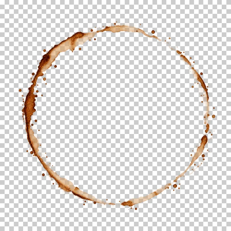 A thin irregular dried coffee cup-ring stain with feathered translucent pigment.