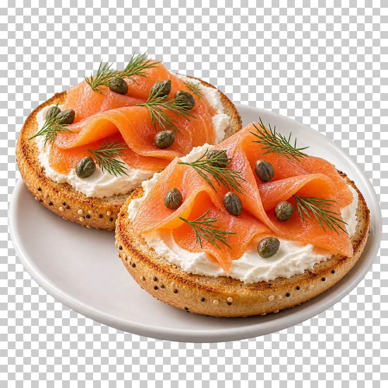 Open smoked salmon and cream cheese bagel halves on a white plate.