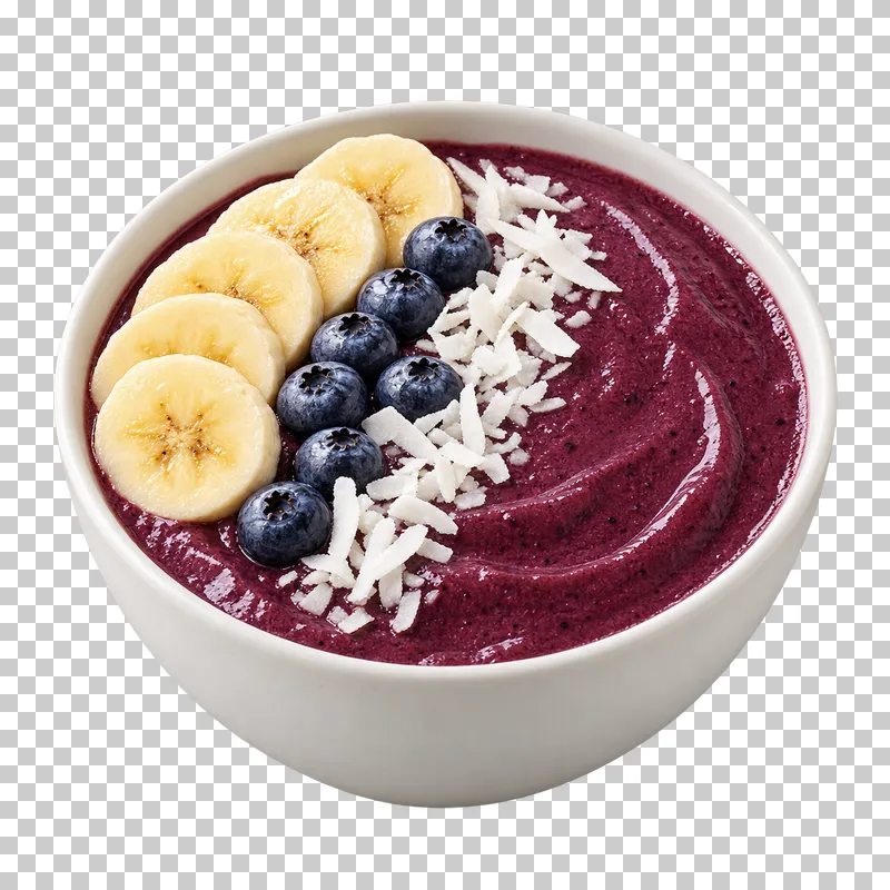 A white acai smoothie bowl topped with banana, blueberries and coconut.