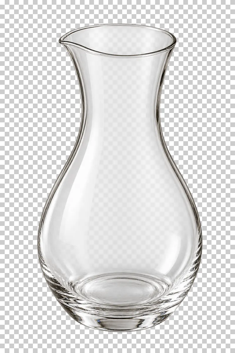 An empty handleless clear-glass water carafe with a narrow neck and pouring lip.